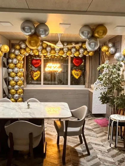 A wider view of the decorated dining space, showing how even a simple setup can transform a room for a celebration.