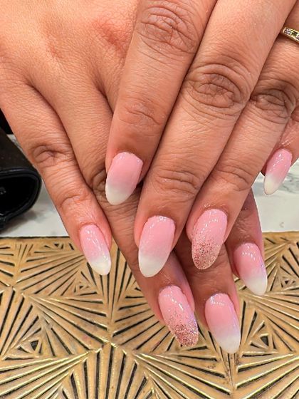 Classic baby boomer ombre nails on an elegant almond shape. This set is enhanced with two accent nails featuring a delicate dusting of rose gold glitter.