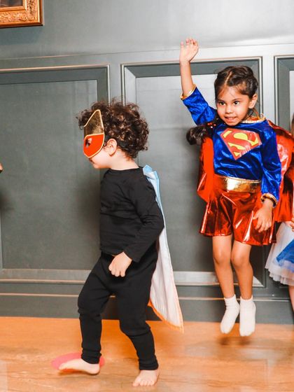 Our superheroes in action, jumping and flying. We use dynamic movements to keep the energy high and the kids engaged.