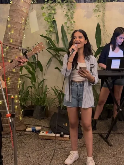 A young singer sharing her voice during our Women's Day celebration. It was a night dedicated to celebrating talent and creating a supportive space for everyone.