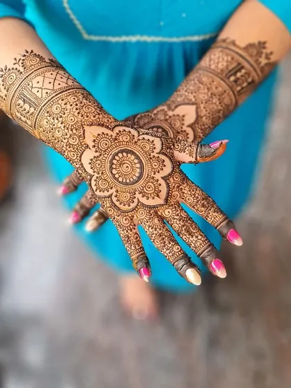 A complete view of this mandala design, showing both hands together to highlight the symmetry and detail.