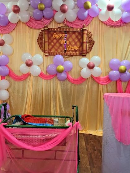 A slightly different arrangement of the purple and pink balloon decor for a girl's naming ceremony.