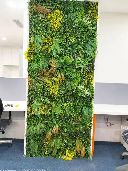 A close-up of the office green wall, showing the high quality and realistic texture of the artificial foliage we use for our corporate projects.