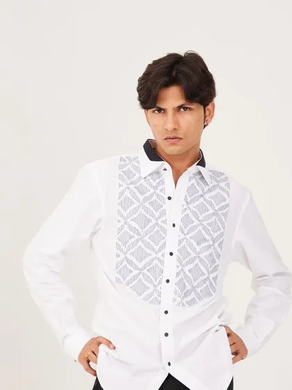 A confident pose in the white pintuck shirt, highlighting the detailed bib and the sharp contrast of the black collar. This is a testament to detailed Indian craftsmanship.