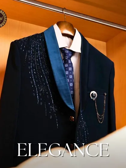 Elegance. The navy tuxedo jacket hanging in a wardrobe, showcasing its beautiful embroidery and readiness for a special occasion.