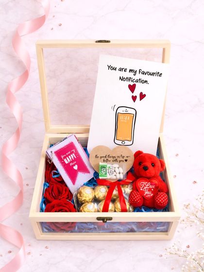 The full view of the wooden birthday hamper. It includes a cute card that says "You are my Favourite Notification," along with Ferrero Rochers, a teddy bear, and other sweet treats.
