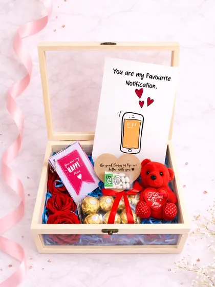 The full view of the wooden birthday hamper. It includes a cute card that says "You are my Favourite Notification," along with Ferrero Rochers, a teddy bear, and other sweet treats.