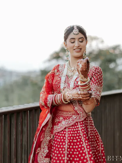This bride is the picture of grace. Her traditional updo is perfectly structured to hold her dupatta in place while she enjoys her wedding rituals.