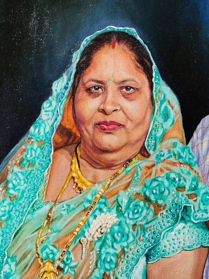 A detailed view of my grandmother's portrait, focusing on the texture and design of her beautiful turquoise saree.