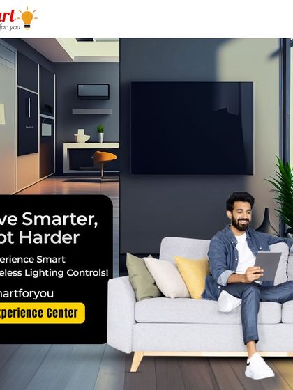 Live smarter, not harder. This image shows a client relaxing while adjusting smart wireless lighting controls from a tablet, a perfect example of the comfort and ease my systems provide.