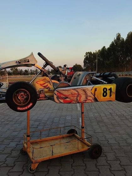 A kart on a stand in the pit area during pre-season testing.