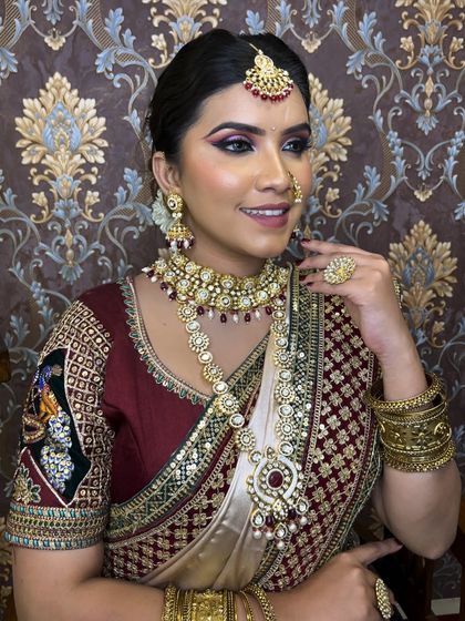 This bride is wearing a layered Polki set with a matching choker, rani haar, and maang tikka, perfect for a grand wedding celebration.