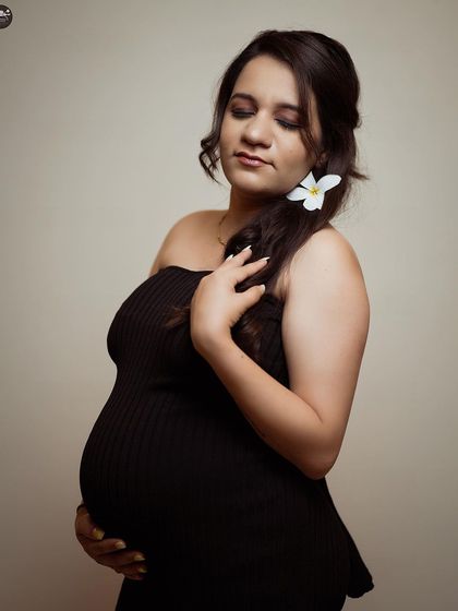 A close-up portrait with a simple flower in her hair. This shot shows how minimal styling can create a beautiful and serene image, focusing on emotion and expression.