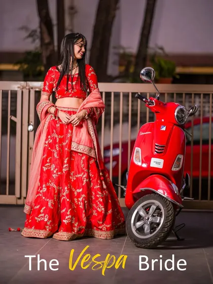 A modern bride with a twist. This playful and unique concept pairs a traditional red lehenga with a vintage red Vespa, creating a fun, memorable, and stylish bridal portrait.