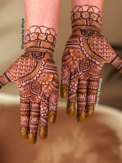 This traditional mehendi is filled with a mix of paisleys, florals, and geometric checks. The lotus details on the fingers and the floral cuff tie the entire intricate design together.