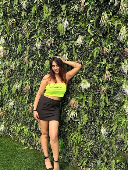 A confident pose in the neon and black combo. This look is all about standing out and having fun.