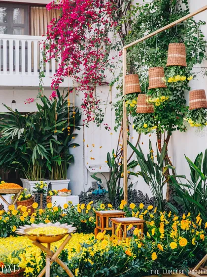 A quaint and sunny Haldi setup in a garden. We used beds of marigolds and hanging floral baskets to create a space that feels both traditional and fresh.