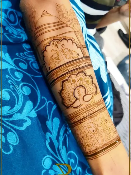 The basic structure of a bridal back-hand design, featuring peacocks, elephants, and floral motifs before the intricate filling is done.