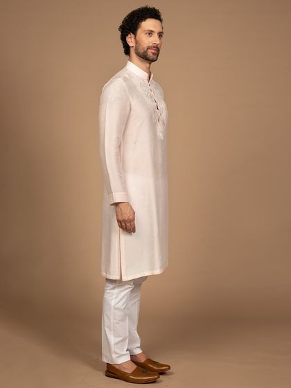 A side profile of the powder pink kurta, showcasing its clean tailoring and perfect fit. It’s a testament to the importance of bespoke craftsmanship in creating a flawless silhouette.