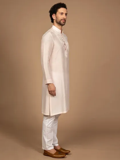 A side profile of the powder pink kurta, showcasing its clean tailoring and perfect fit. It’s a testament to the importance of bespoke craftsmanship in creating a flawless silhouette.