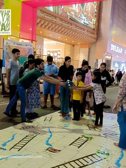 Community members playing a giant game of snakes and ladders on a public street. Our work often involves supporting and participating in tactical urbanism events that demonstrate the potential for our streets to become places for play, interaction, and community building.