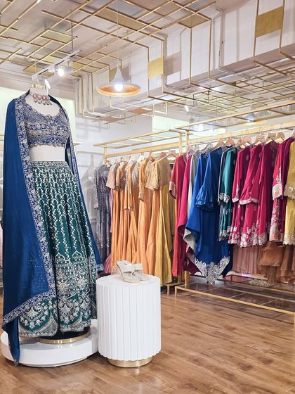 A look inside Armadio, where a statement lehenga in jewel tones stands alongside a rack of vibrant festive ensembles. Each piece is selected for its quality and quiet elegance.