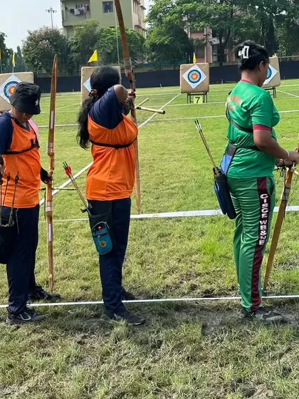 Another view of the archers at the national competition, showcasing the colorful uniforms and focused atmosphere of the event.