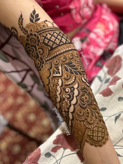 A close-up of the forearm portion of Afnaz's Pakistani bridal henna, highlighting the intricate details and bold lines.