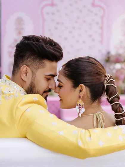 An intimate and playful moment between the couple during their Haldi ceremony, their noses touching in a sweet "eskimo kiss."
