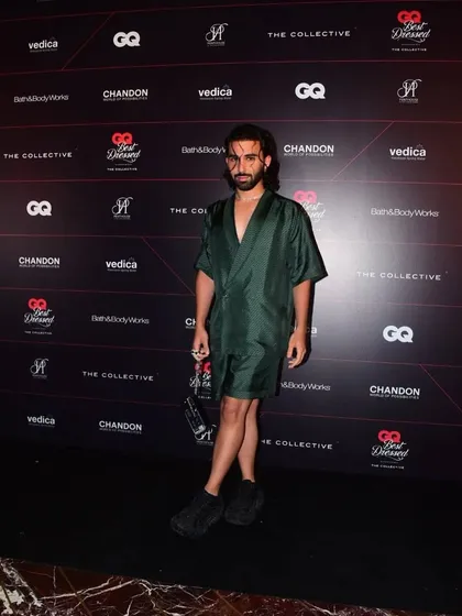Orry posing on the red carpet at the GQ Best Dressed event. The dark green silk ensemble I styled for him was modern, unique, and perfectly captured his personal style.