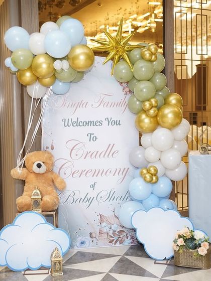 The personalized welcome sign for the 'A Star is Born' cradle ceremony, adorned with balloons and cloud cutouts, setting the celestial theme from the moment guests arrive.