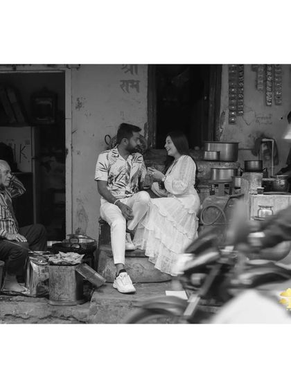 Finding romance in everyday places. This black and white shot at a local tea stall is authentic and tells a story about the couple's journey, capturing a real, unposed moment.