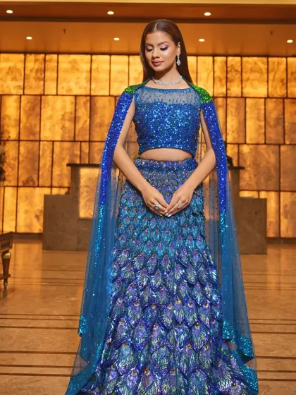 Make a grand entrance at your sangeet or reception with this showstopping peacock-inspired lehenga. The vibrant blue sequins and unique feather-like design create a look that is both glamorous and unforgettable.