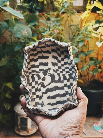 Stuti experimented with Nerikomi to create this wonderfully distorted checkerboard tray. The wavy, organic edges add to its playful, handmade charm.
