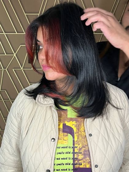 A bold and trendy look featuring red money pieces and chunky highlights. This is a great way to add a pop of personality to your hair.