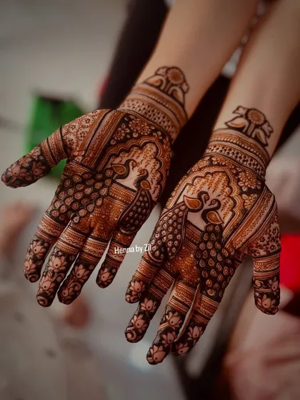 A lovely engagement mehendi featuring graceful peacocks on the palms, perfect for a bride who loves traditional motifs.