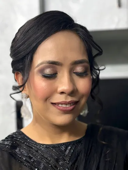 A close-up of the shimmery eye makeup, showing the blend of bronze and gold tones that make the eyes pop.