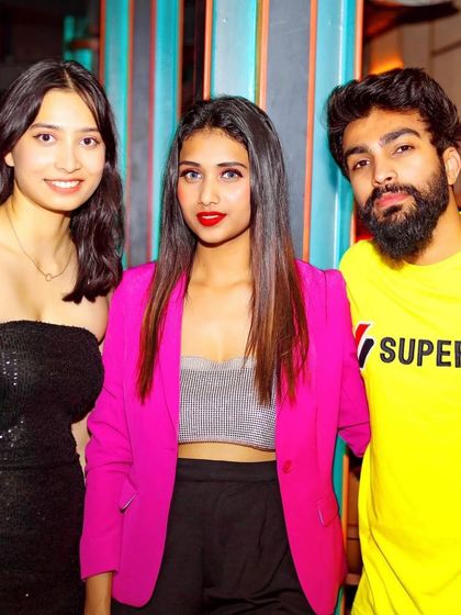 Posing with guests at The Fixx Bar. I always make time to connect with the people who come to my shows.