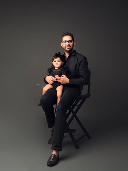 A dapper dad holding his equally stylish little girl. A great father-daughter portrait.