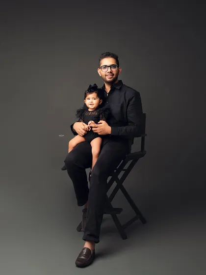 A dapper dad holding his equally stylish little girl. A great father-daughter portrait.