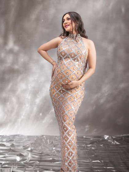 A beautiful three-quarter portrait, capturing her happy expression and the stunning details of the sequined dress.