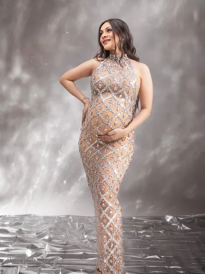 A beautiful three-quarter portrait, capturing her happy expression and the stunning details of the sequined dress.