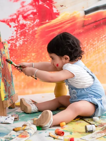 An artist at work. This creative painting session allows children to express themselves and get a little messy, resulting in authentic and joyful photos.