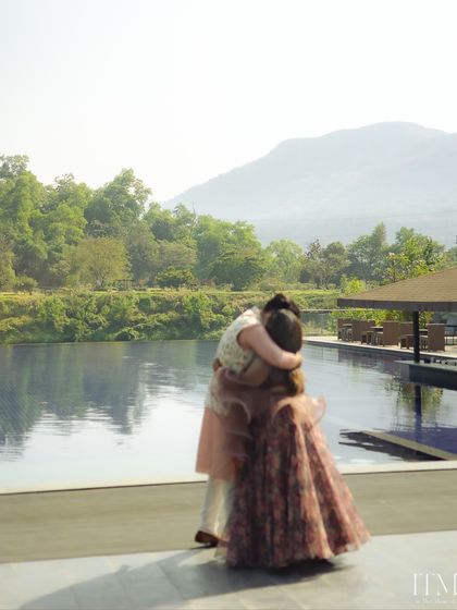 A tender embrace by the infinity pool at Oleander Farms. The reflection in the water and the mountain backdrop add a sense of grandeur to this intimate couple portrait.
