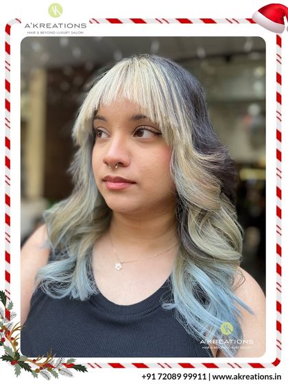 A high-fashion look combining a dark base with a split dye of platinum blonde and pastel blue for a truly artistic and unique style.
