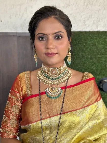 A classic look for a client in a traditional silk saree. The makeup is timeless, with a focus on defined eyes and a flawless complexion.