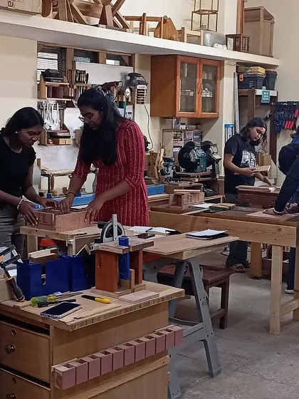 The workshop buzzing with activity as design students work on their projects. It's a day of intense learning, creativity, and sawdust.