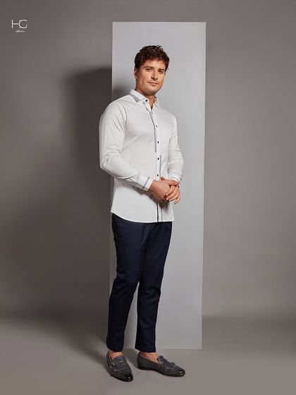 A full-length view of the detailed white shirt, paired with navy trousers. It's a versatile look that works for any occasion, from the office to a dinner party.