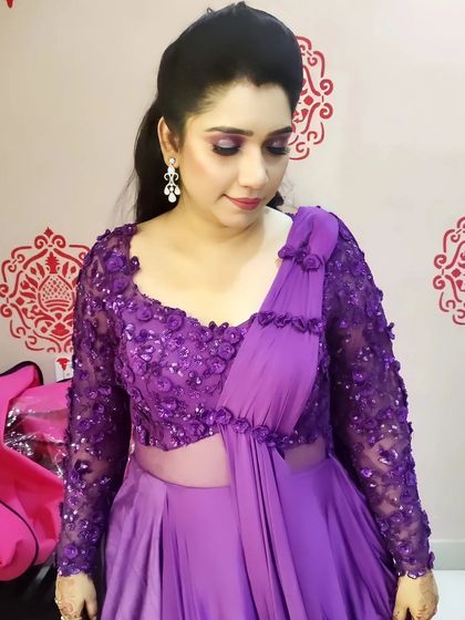 A three-quarter view of the soft purple smokey eye and sleek hairstyle. This look is perfect for any festive occasion or family function where you want to look polished and put-together.