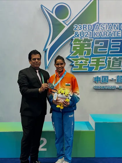 A personal moment of congratulations with Ms. Rusha Tambat after her win at the Asian Championship. Mentoring our players is a key part of my role.